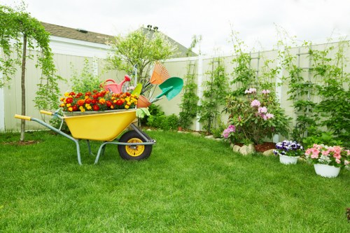 Operative using hedge trimmer with appropriate PPE